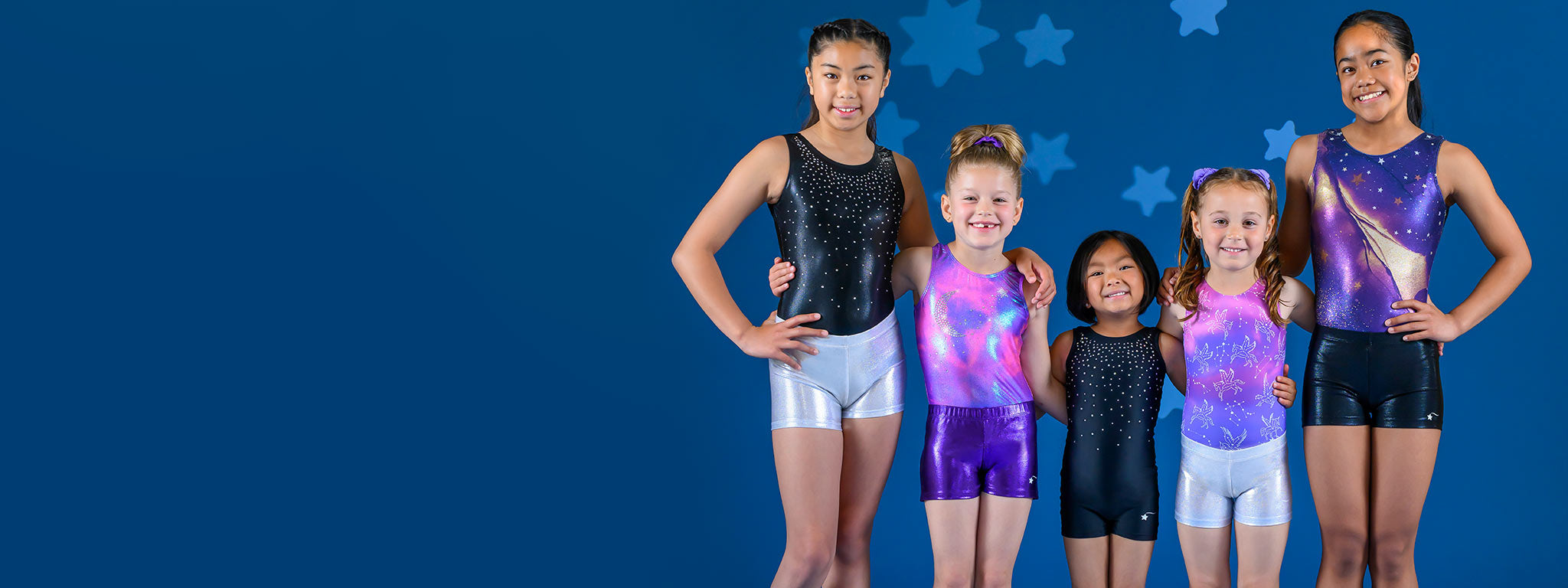 Five gymnasts ranging from young ages to teens wearing galaxy themed girls gymnastics clothes by Destira, 2023