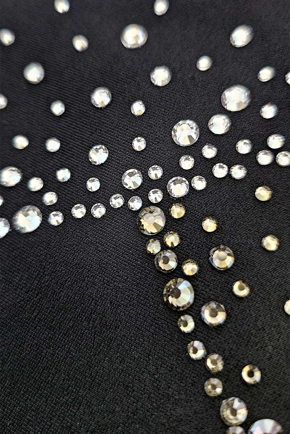 Rhinestone detail on black leotard by Destira, 2024