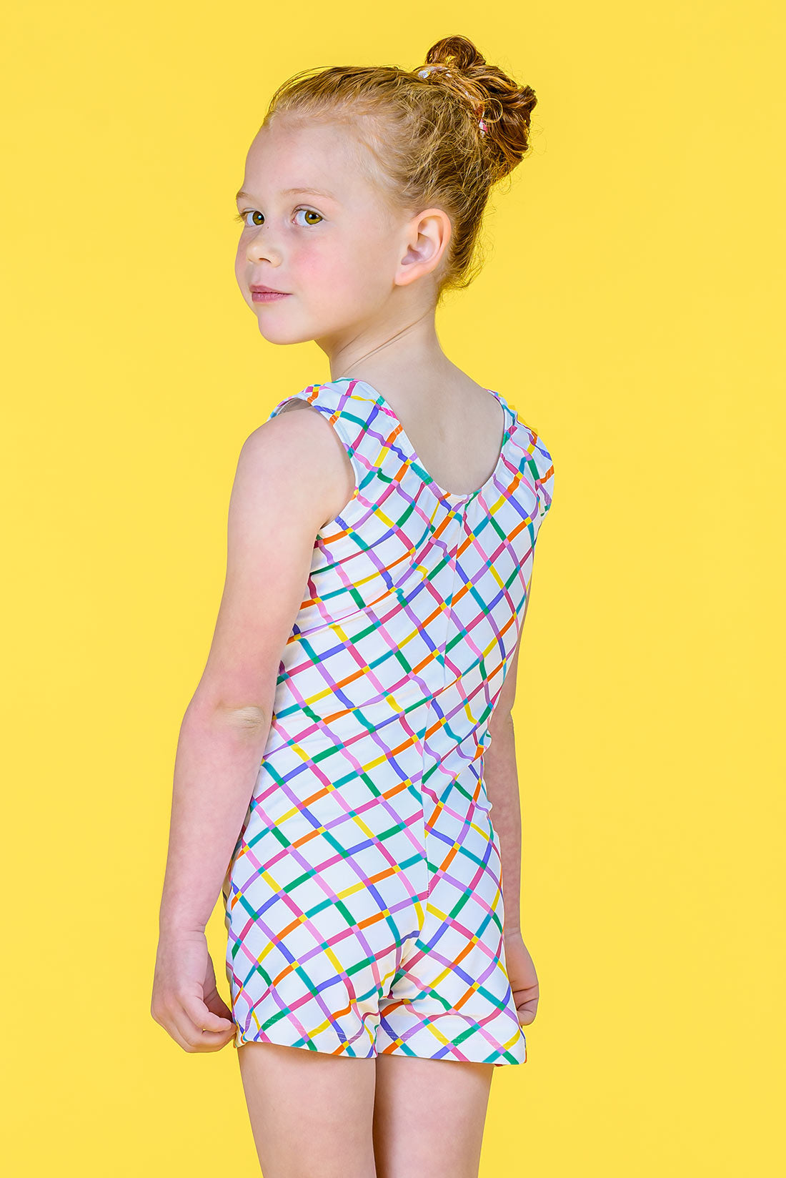 White biketard with vibrant rainbow pattern for girls in gymnastics and dance by Destira, 2024