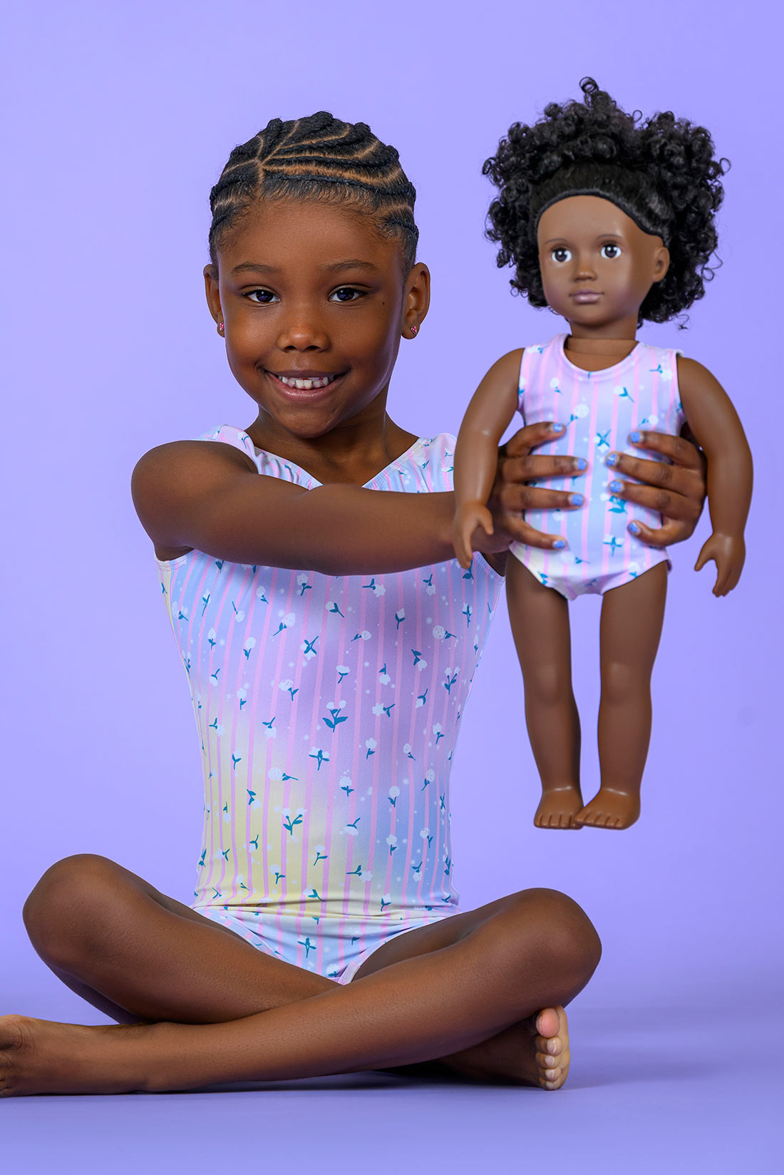Matching purple gymnastics outfits for girls and their dolls by Destira, 2026