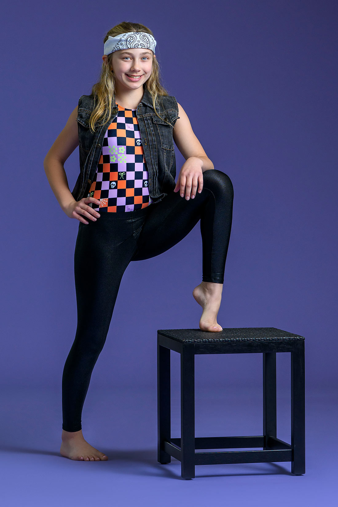 Girls Halloween gymnastics leotard with fun spooky checkered design paired with black leggings for tweens and teens
