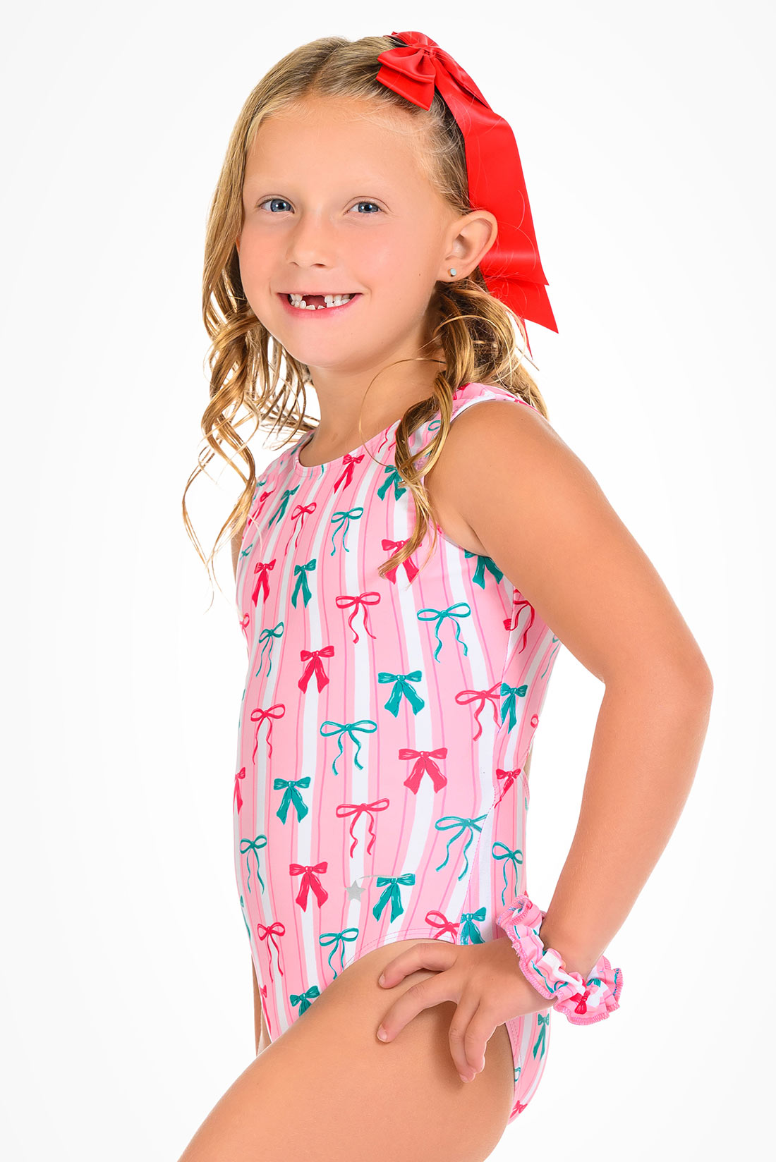 Pink striped leotard with green and red bows by Destira, 2026