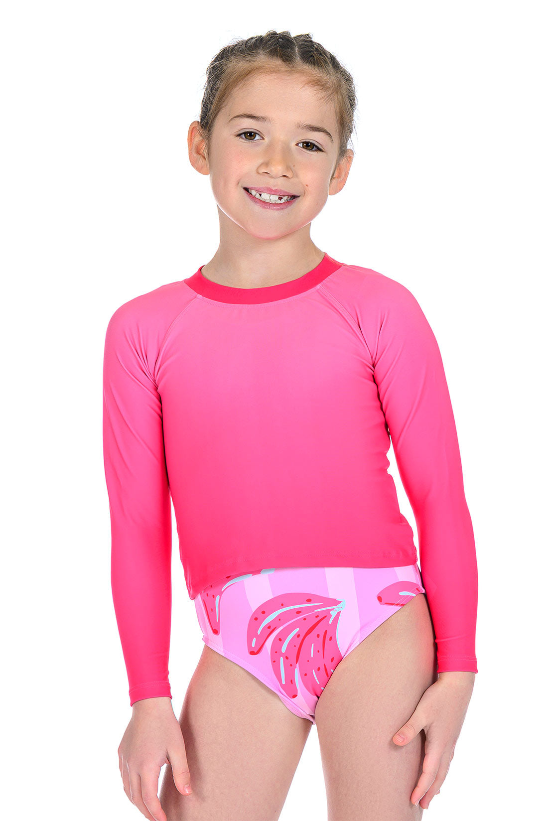 Child wearing a pink long-sleeve rash guard over a patterned pink swimsuit showing front view
