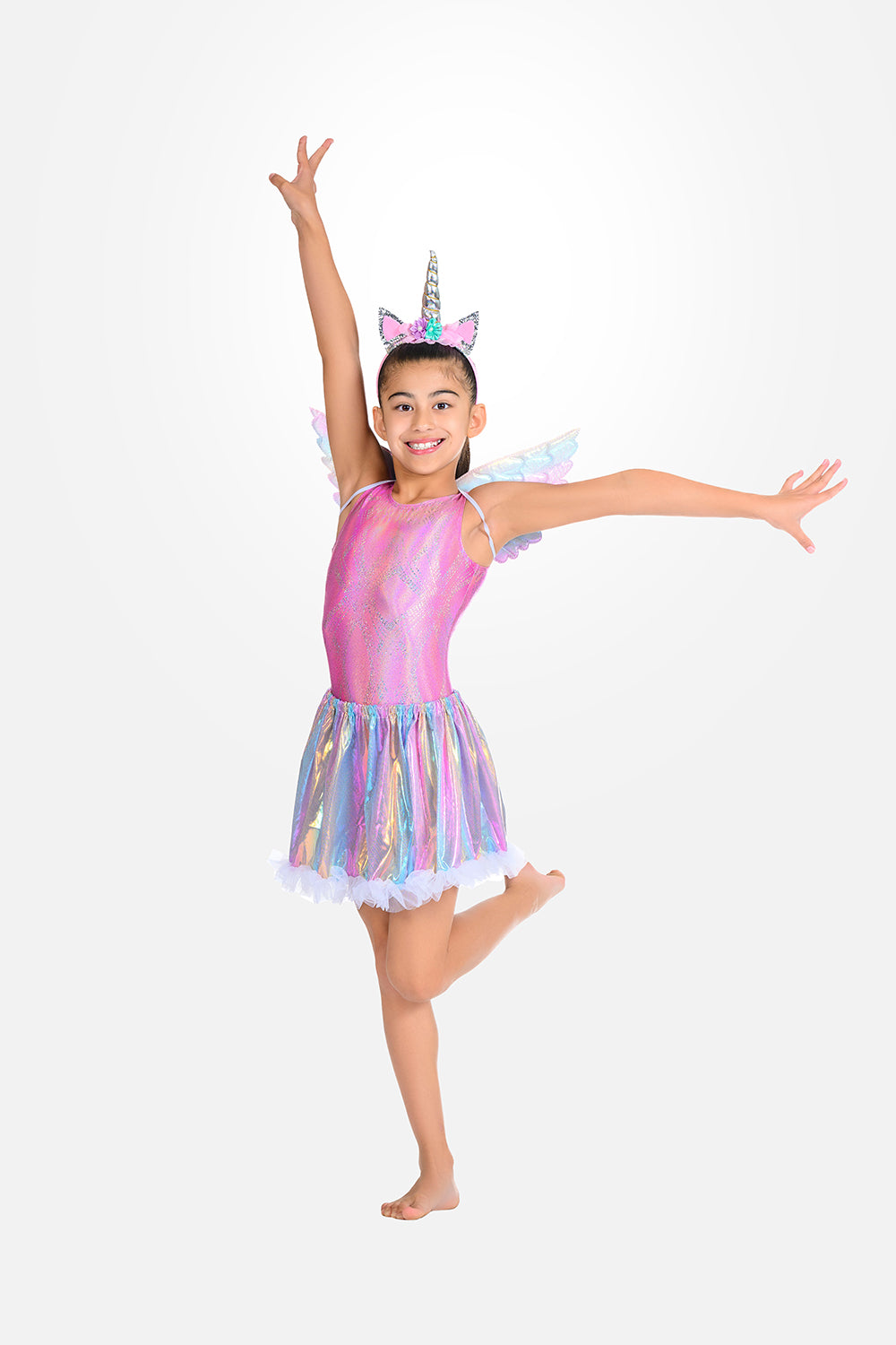 A young girl modeling a pink unicorn-themed dance costume with a shiny iridescent skirt, angel wings, and a horn headband, pDestira 2026
