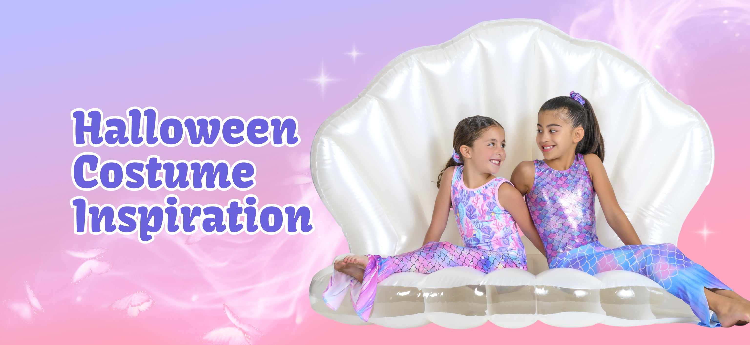Two young girls wearing mermaid-style Halloween costumes sit on a large white inflatable clam shell prop against a pink and purple gradient background with the text 'Halloween Costume Inspiration' on the left.