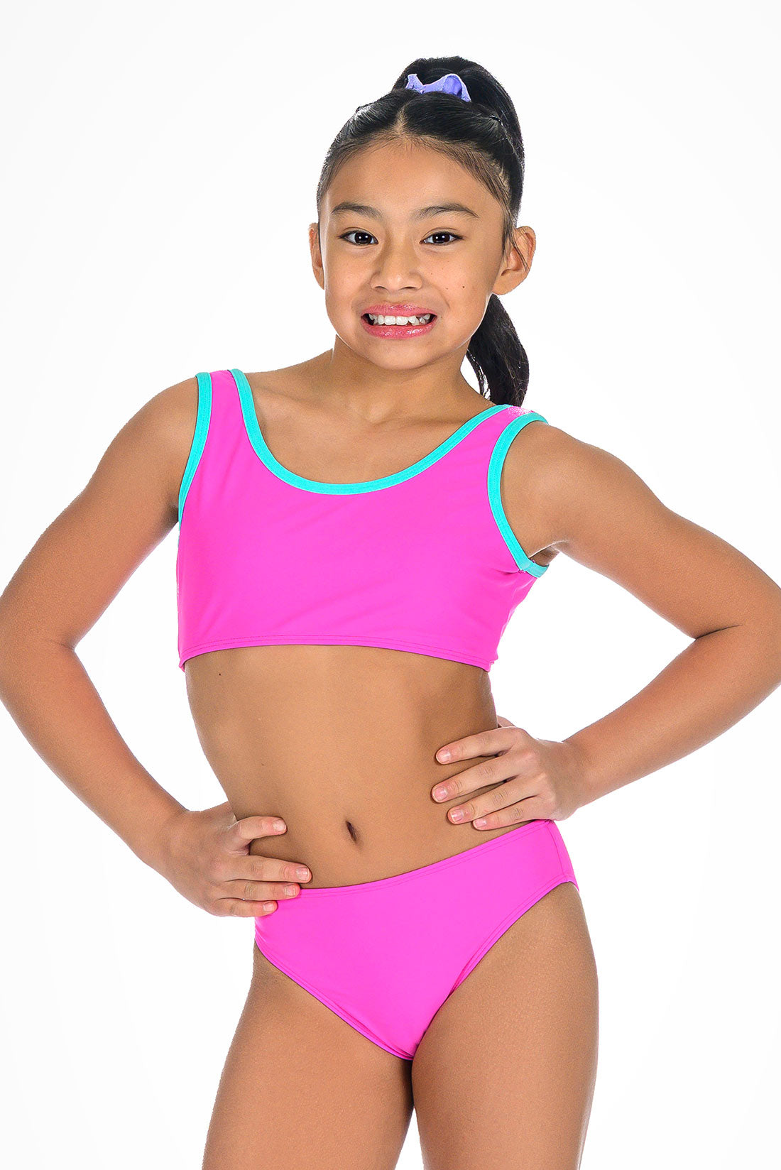 Young girl wearing a pink bikini with turquoise trim on a white background showing front view