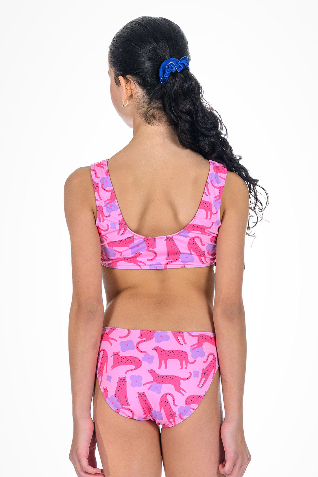 Girl wearing a pink and purple patterned bikini set on a white background showing back view